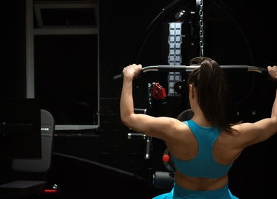 Woman exercising at The Galpals Collective gym, Douglas, Douglas, IM, showcasing strength and well-being.
