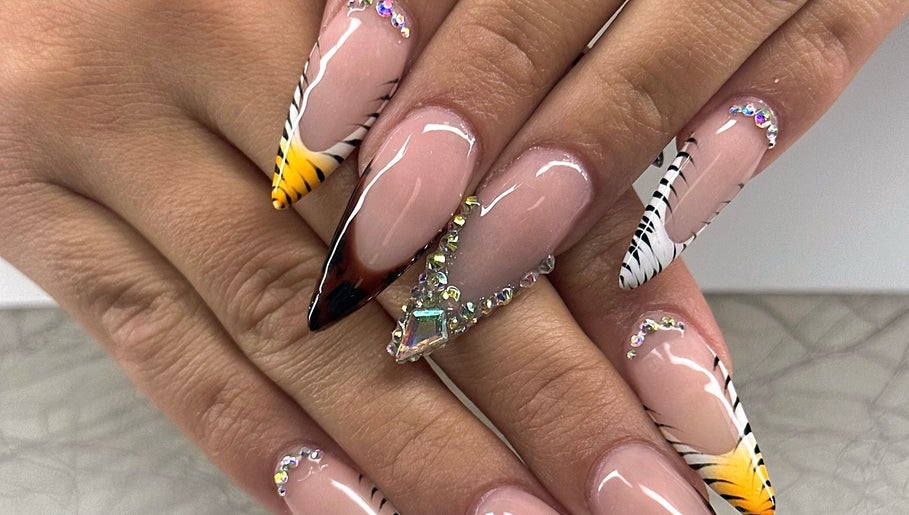 Stunning nail art design at Honey & Clove Nails, Sylvan Lake, Alberta, CA with gems and zebra stripes.