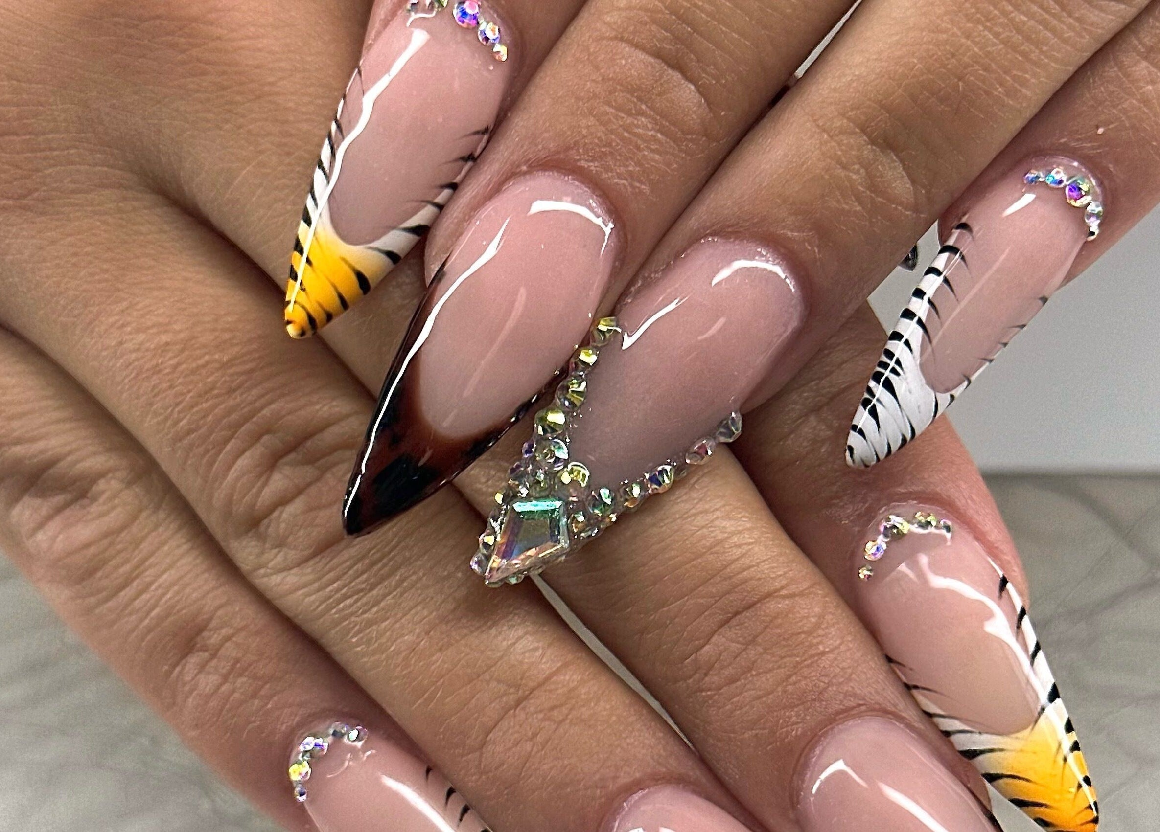 Stunning nail art design at Honey & Clove Nails, Sylvan Lake, Alberta, CA with gems and zebra stripes.