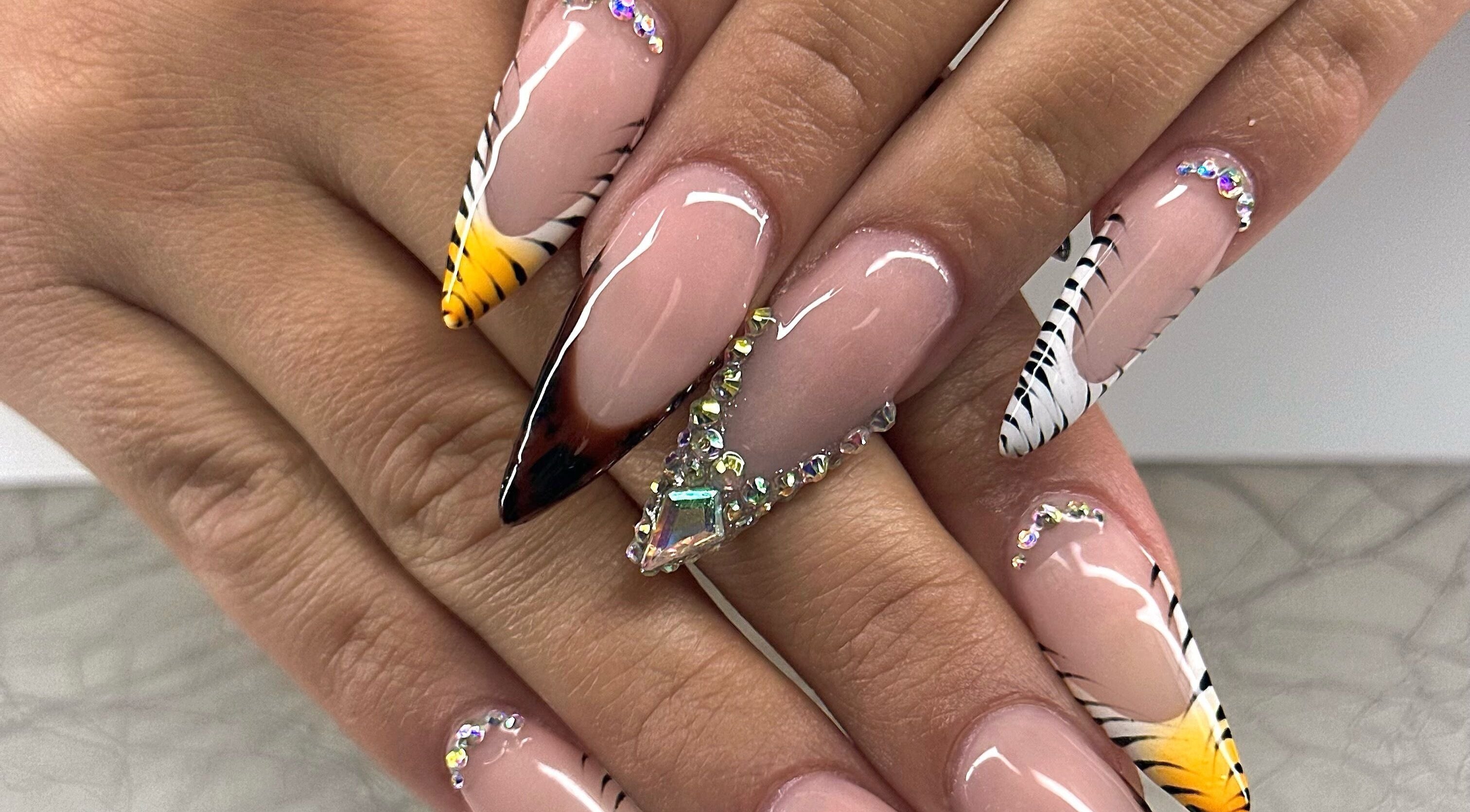 Stunning nail art design at Honey & Clove Nails, Sylvan Lake, Alberta, CA with gems and zebra stripes.