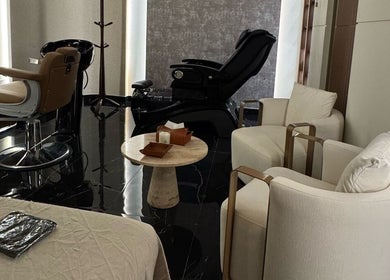Stylish interior of Generation Gentleman Barbershop, Dubai, featuring plush chairs and modern decor.