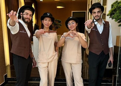 Friendly team at Generation Gentleman Barbershop welcoming guests at entrance in دبي, دبي, AE.