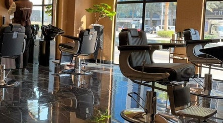 Interior view of Generation Gentleman Barbershop in دبي, دبي, AE with sleek barber chairs and modern decor.