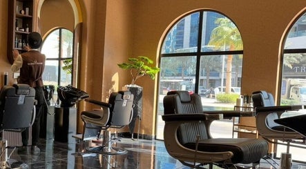 Chic interior of Generation Gentleman Barbershop in دبي, دبي, AE, showcasing stylish barber chairs and decor.