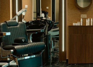 Elegant barber chair inside Generation Gentleman Barbershop, Dubai, AE, showcasing modern interior design.