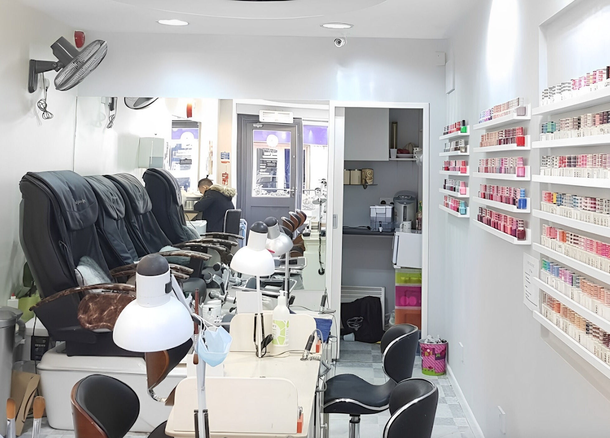 Modern nail salon interior at Coco's Nails, Basingstoke, England, GB, featuring luxurious pedicure chairs.
