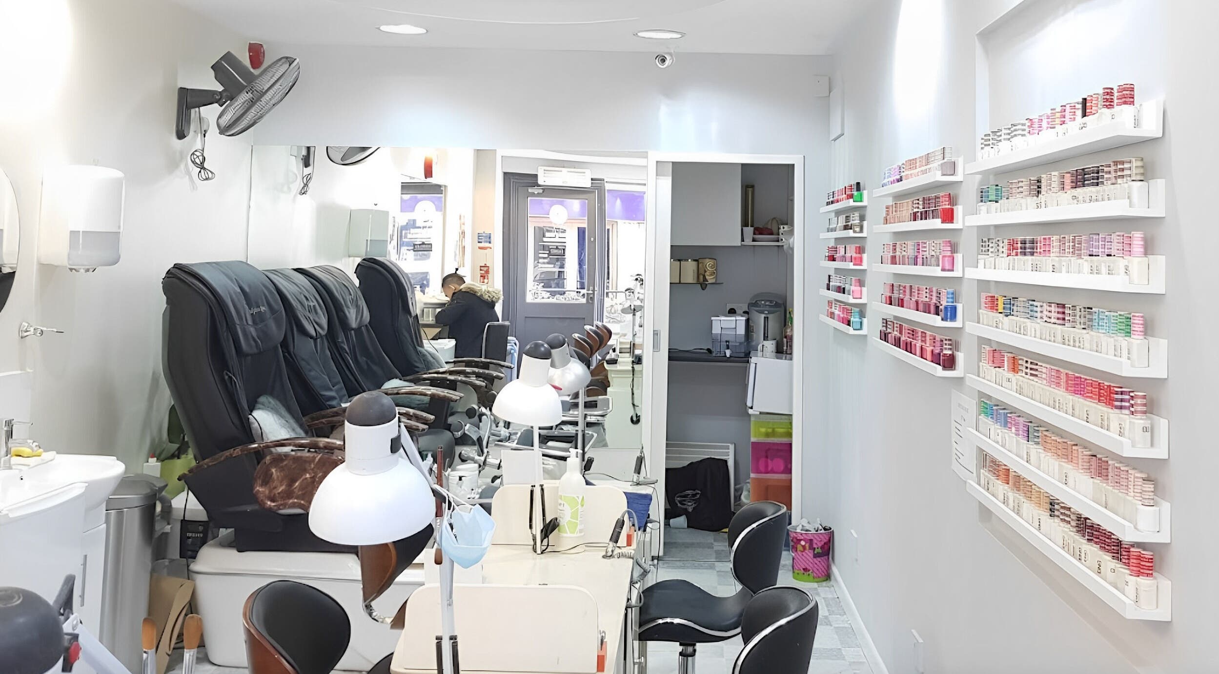 Modern nail salon interior at Coco's Nails, Basingstoke, England, GB, featuring luxurious pedicure chairs.