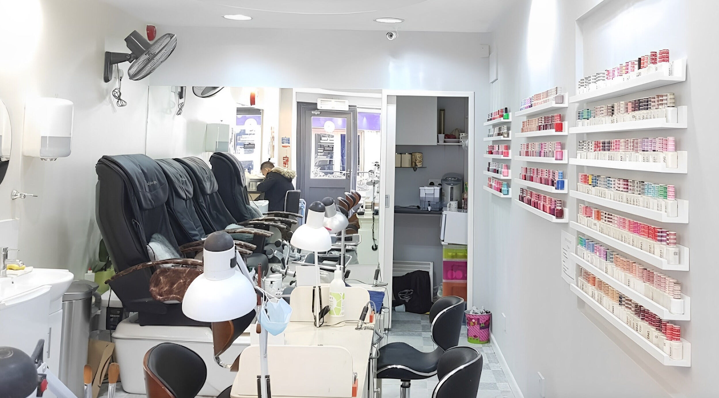 Modern nail salon interior at Coco's Nails, Basingstoke, England, GB, featuring luxurious pedicure chairs.