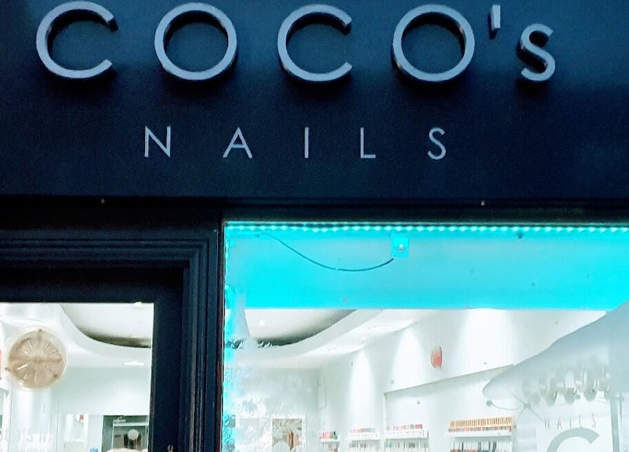 Coco's Nails storefront with glowing blue lights in Basingstoke, England, GB.