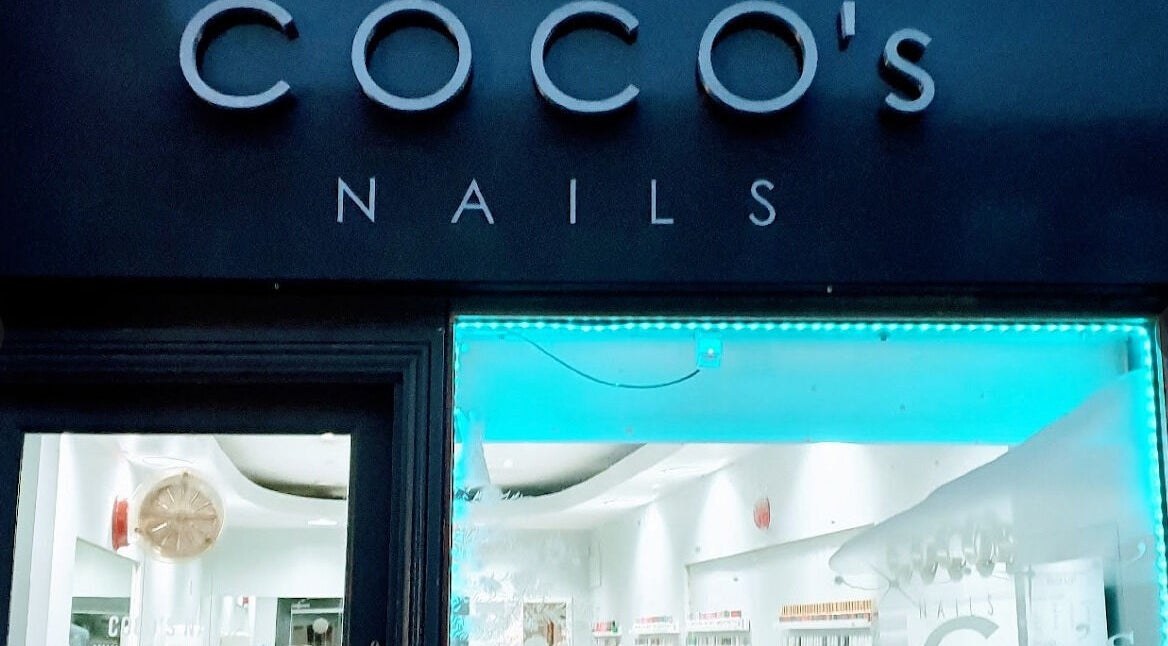 Coco's Nails storefront with glowing blue lights in Basingstoke, England, GB.