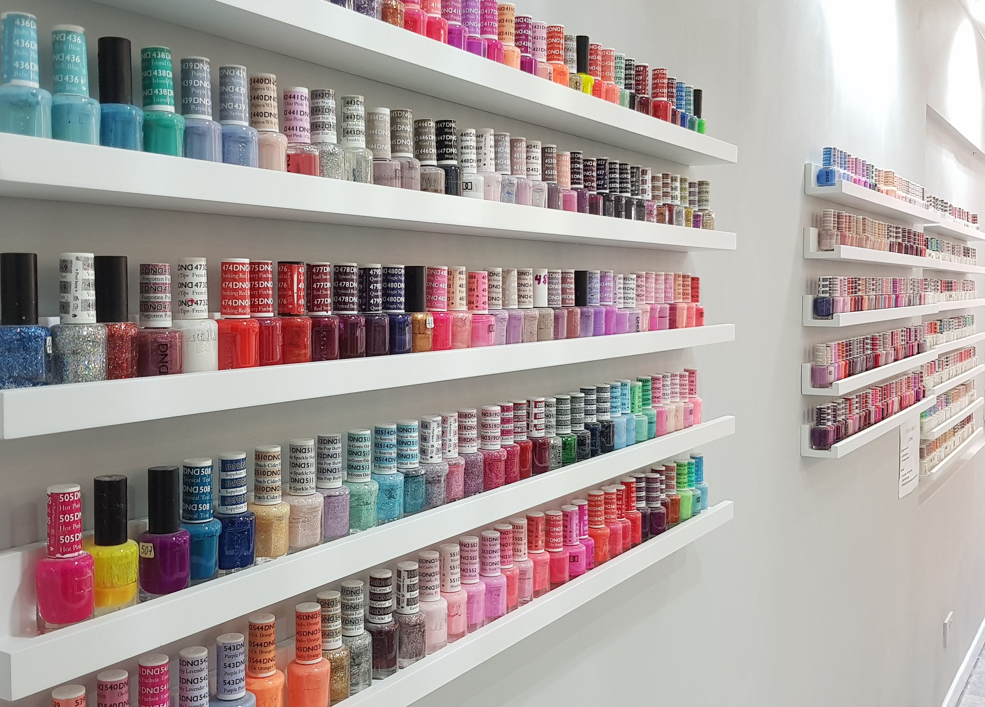 Rainbow of nail polish displayed at Coco's Nails, Basingstoke, England, GB.