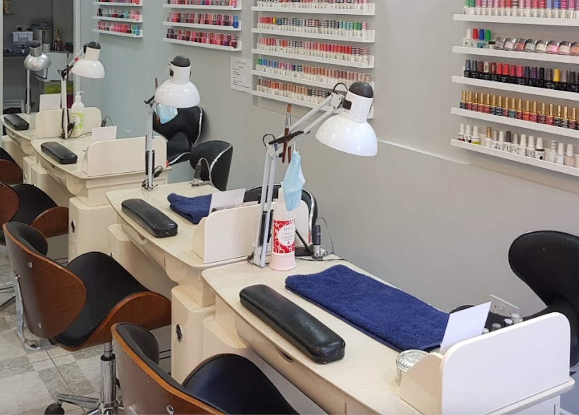 Elegant nail stations at Coco's Nails in Basingstoke, England, GB, showcasing a variety of vibrant polish displays.
