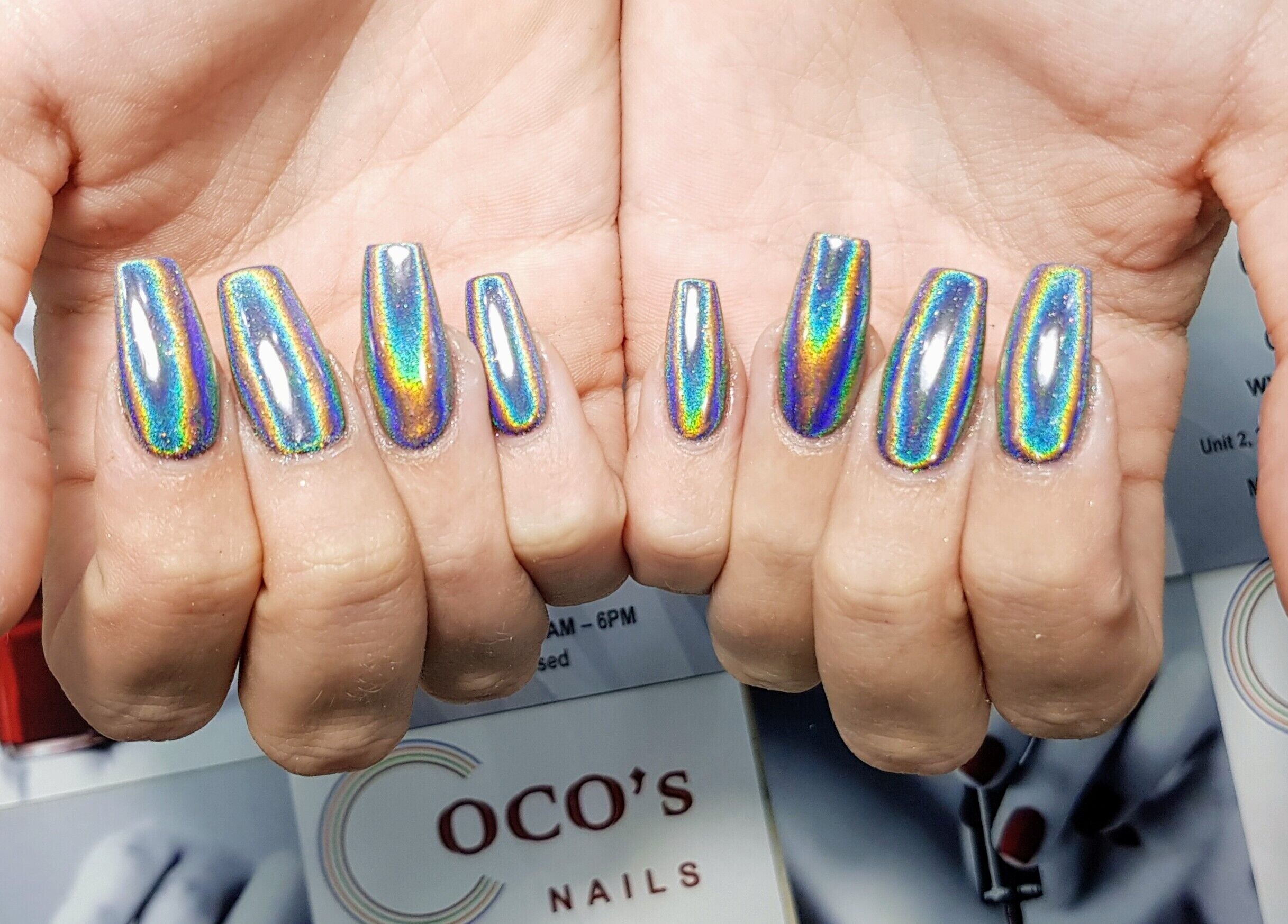 Vibrant holographic nails at Coco's Nails, Basingstoke, England, GB, showcasing colorful nail art.
