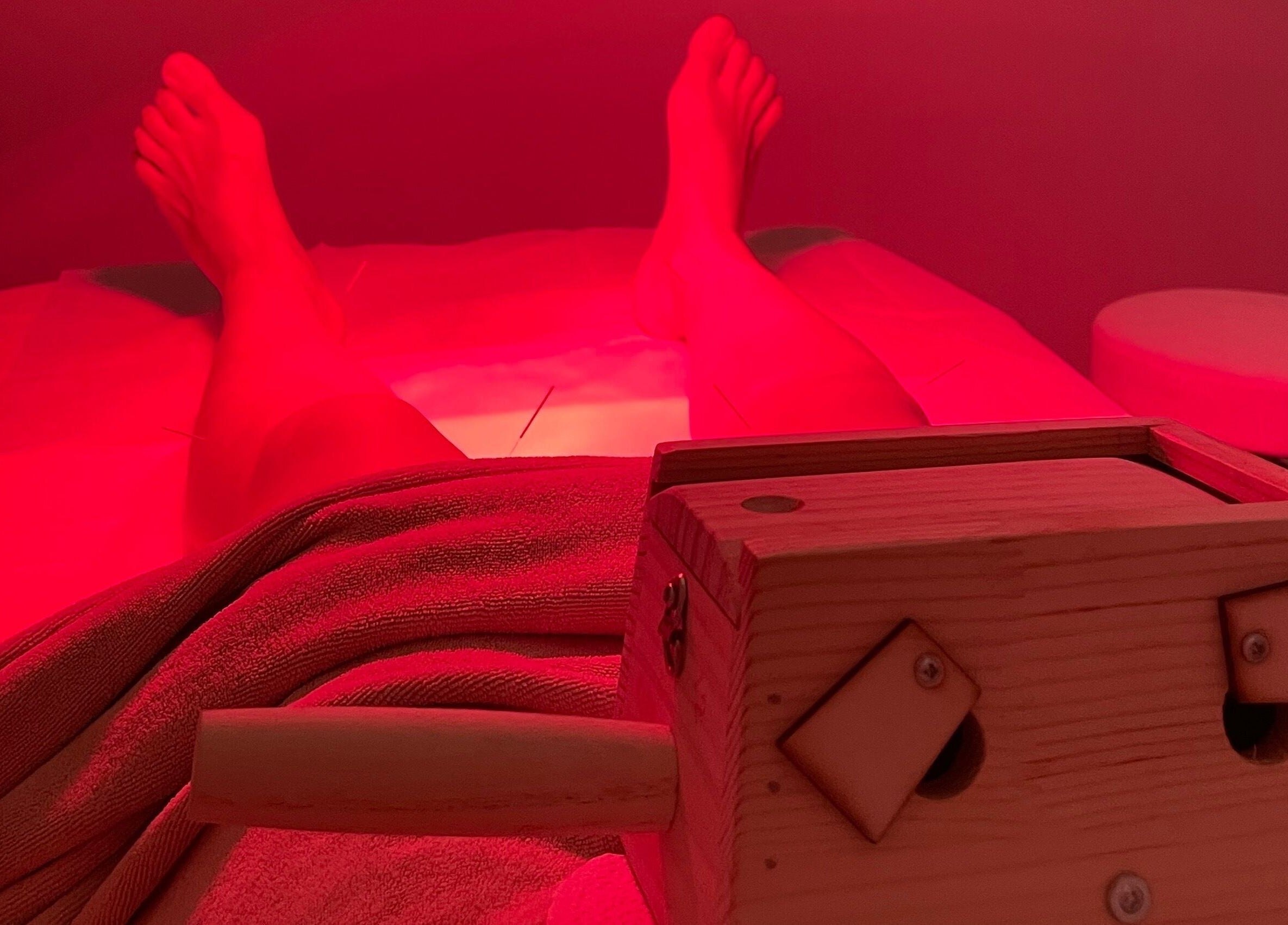 Relaxing red light therapy at Ai Ling TCM & Acupuncture, Petaling Jaya, Selangor, MY showcasing serene ambiance.