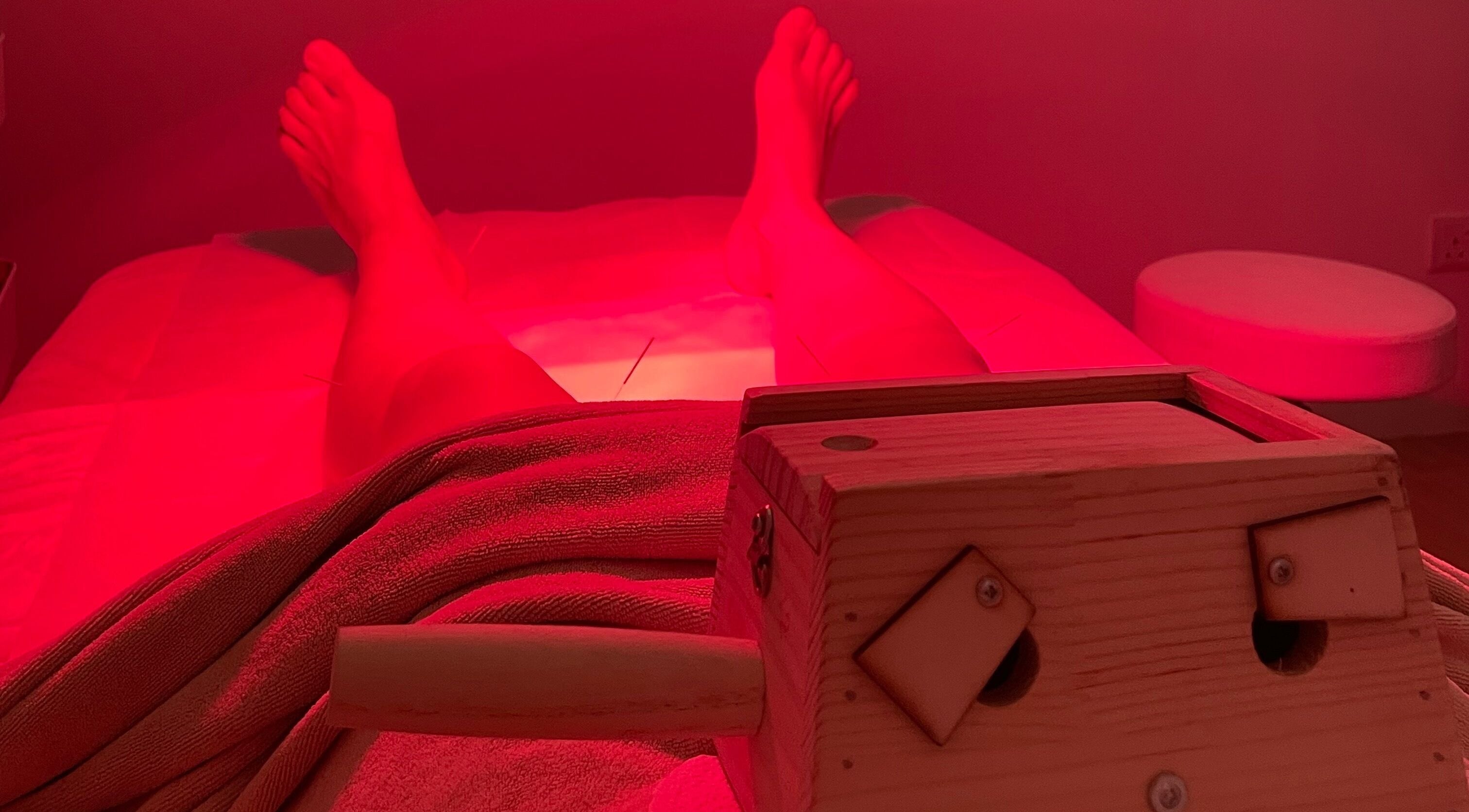 Relaxing red light therapy at Ai Ling TCM & Acupuncture, Petaling Jaya, Selangor, MY showcasing serene ambiance.