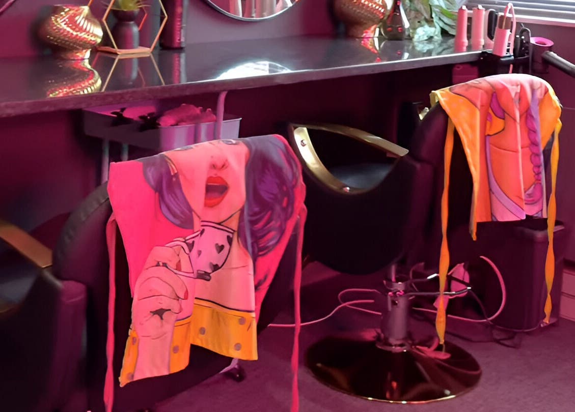 Stylish salon chairs with pop art towels at Clēa Headspa, Cape Town, Western Cape, ZA, under warm lighting.