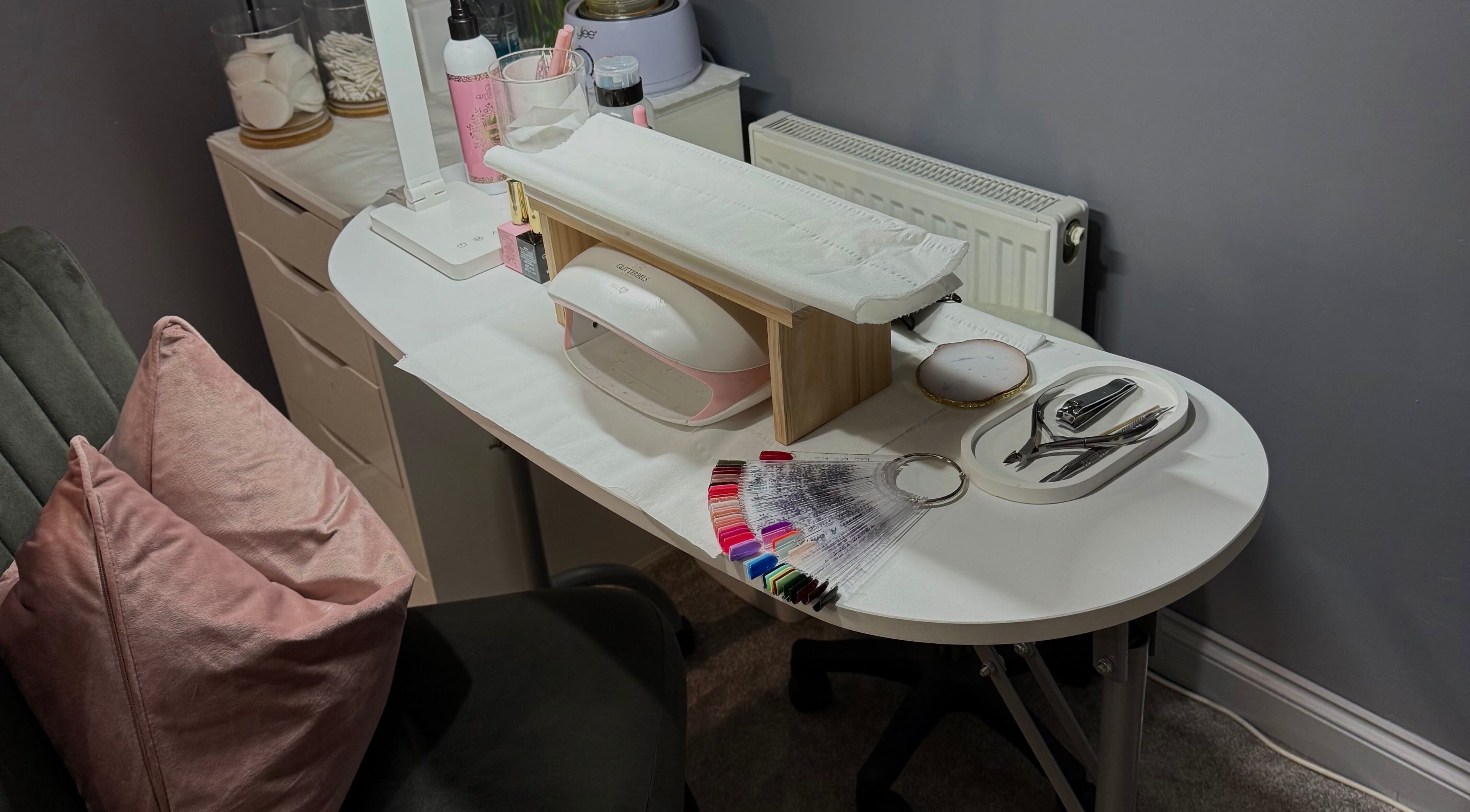 Chic nail station at Beauty By Caitlin, Chalford, England, GB, showcasing manicure tools and polish samples.