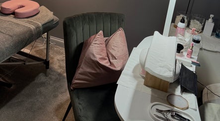 Cozy treatment area at Beauty By Caitlin, Chalford, England, GB with a plush chair and preparation table.