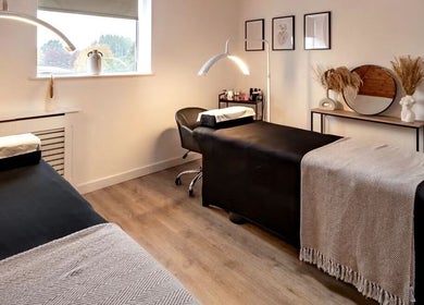 Elegant treatment room at CC Cosmetics, Exeter, England, GB, featuring modern decor and massage beds.