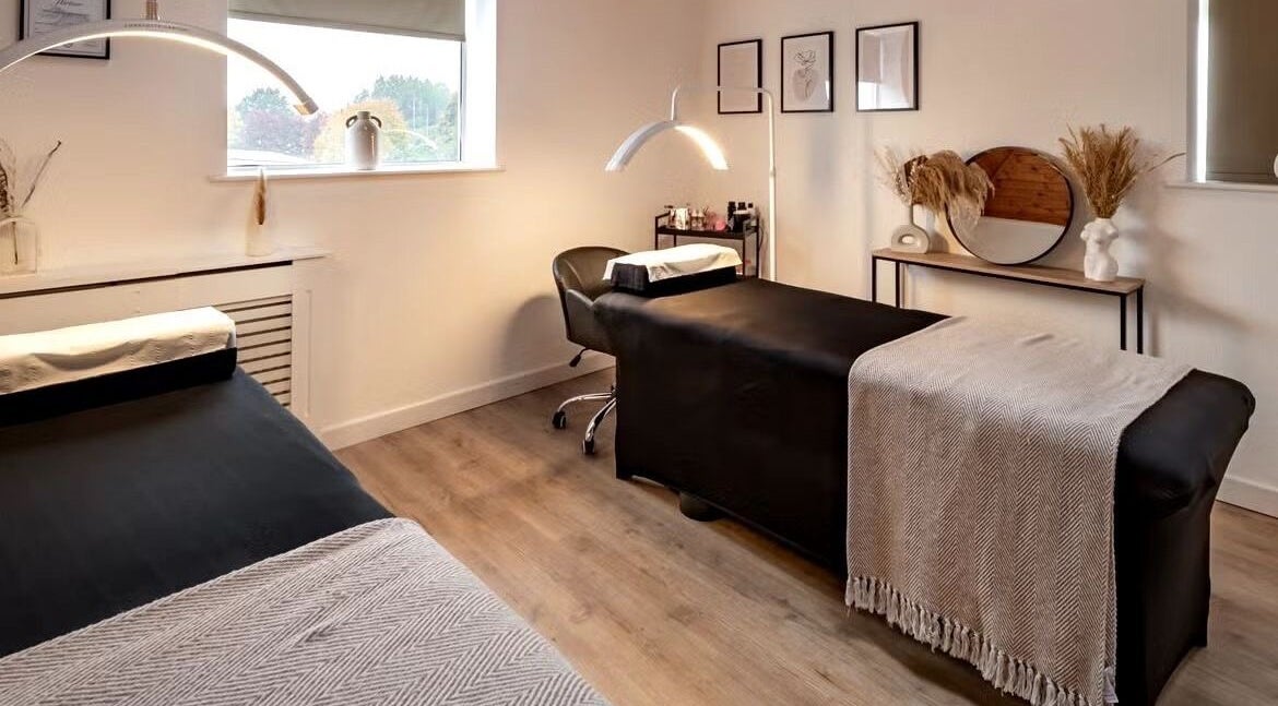 Elegant treatment room at CC Cosmetics, Exeter, England, GB, featuring modern decor and massage beds.