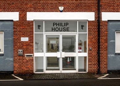 Entrance to CC Cosmetics at Philip House, Exeter, England, GB with modern glass doors.