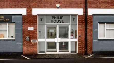 Entrance to CC Cosmetics at Philip House, Exeter, England, GB with modern glass doors.