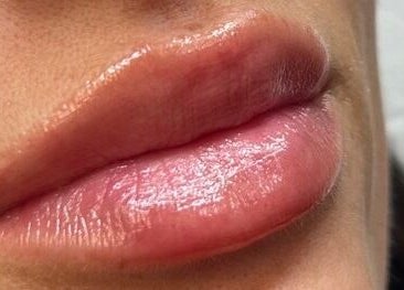 Close-up of glossy lips at CC Cosmetics, Exeter, England, GB highlighting smooth texture and shine.