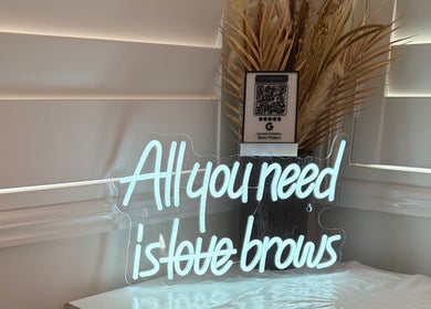 Neon sign at Jeanette N Beauty Therapist, Wakerley, Queensland, AU, saying 'All you need is love brows'.