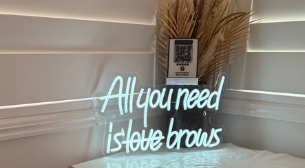 Neon sign at Jeanette N Beauty Therapist, Wakerley, Queensland, AU, saying 'All you need is love brows'.