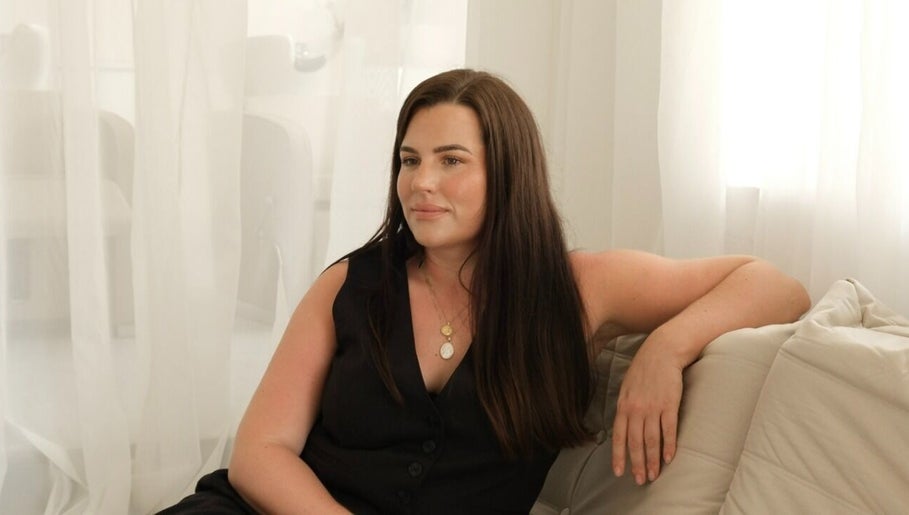 Woman relaxing at The Integrative Studio, Fairy Meadow, New South Wales, AU, exemplifying calm elegance.
