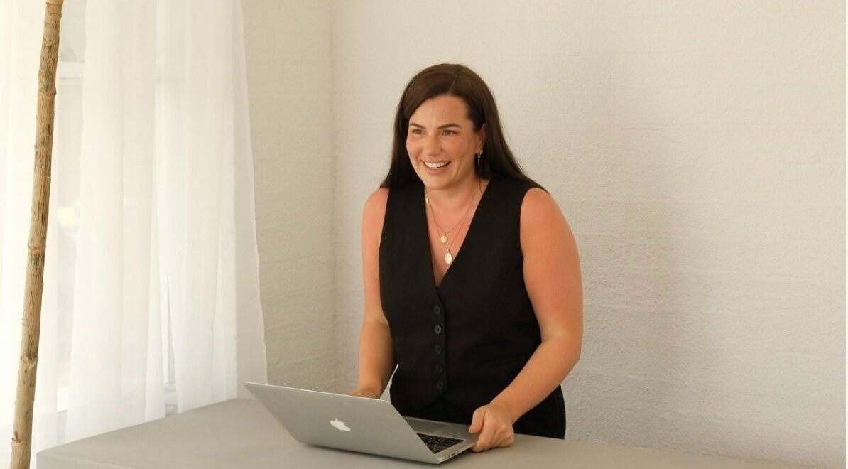 Smiling woman at The Integrative Studio, Fairy Meadow, New South Wales, AU, enhancing client experience.