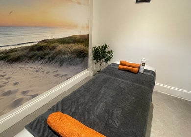 Tranquil massage room at Bramhall Clinic KT Sports Massage & Rehab, Bramhall, England, GB with seaside mural.