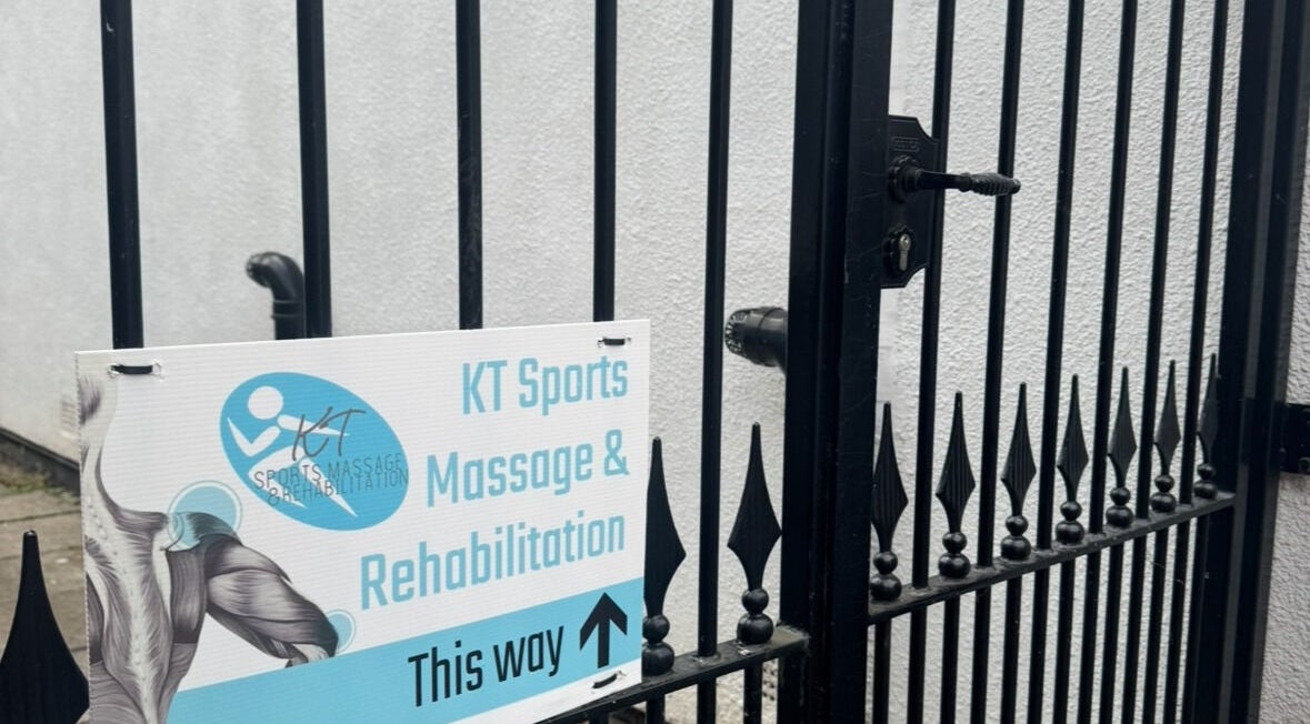 Signage pointing to KT Sports Massage & Rehabilitation Bolton Clinic, Westhoughton, England, GB.