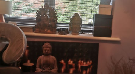 Buddha statues in a peaceful setting at Sanctuary Reflexology, York, England, GB, enhancing relaxation ambiance.
