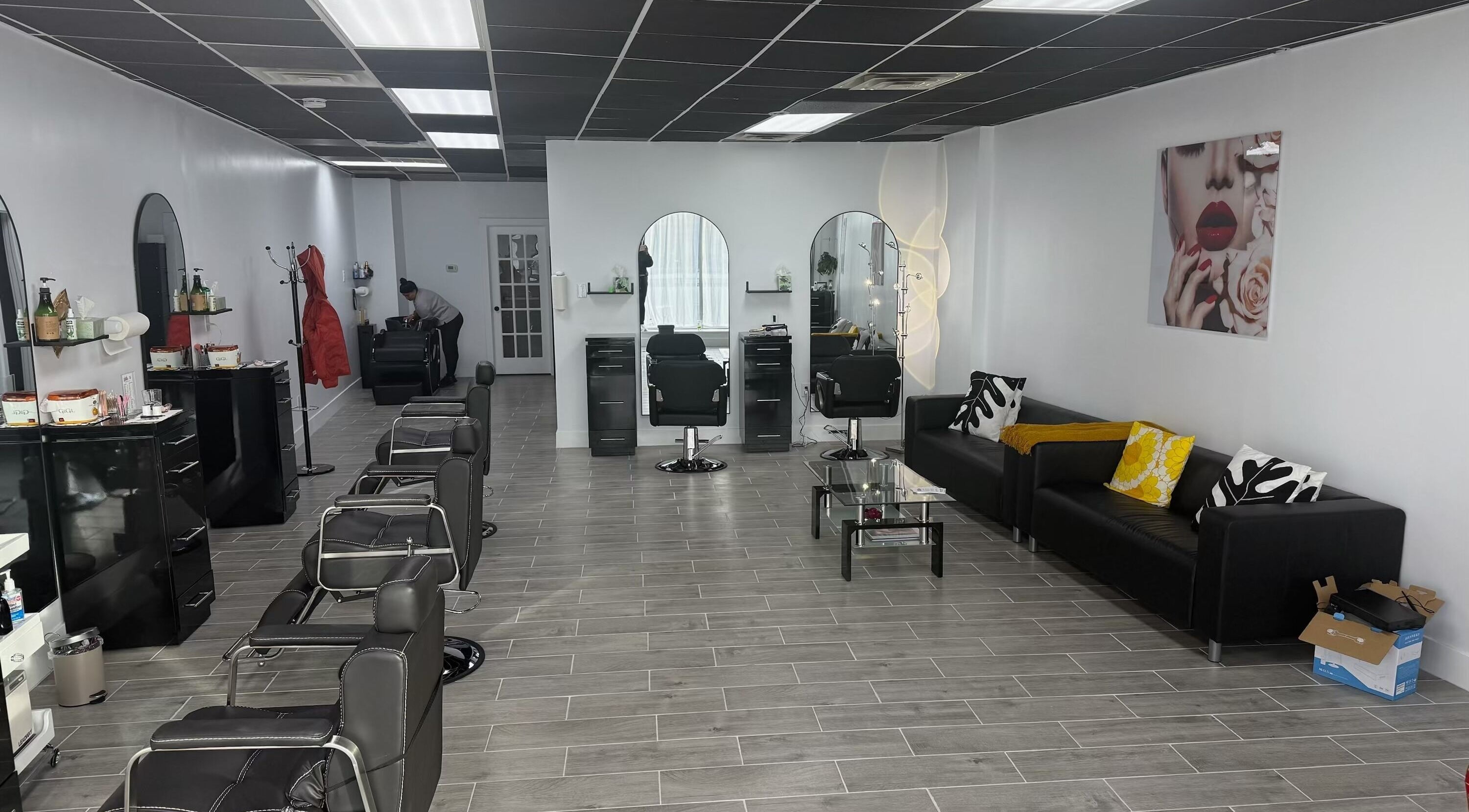 Interior of Looks Threading & Hair Salon in Westbury, New York, US, featuring sleek chairs and modern decor.