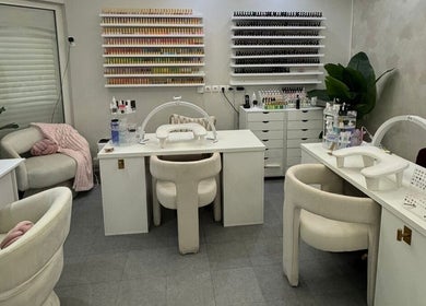 Chic nail studio at Le Getaway by Lexx, Marigot, GP with plush chairs and nail polish displays.