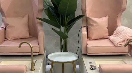 Plush pink pedicure chairs at Le Getaway by Lexx in Marigot, GP, offering a luxurious spa experience.