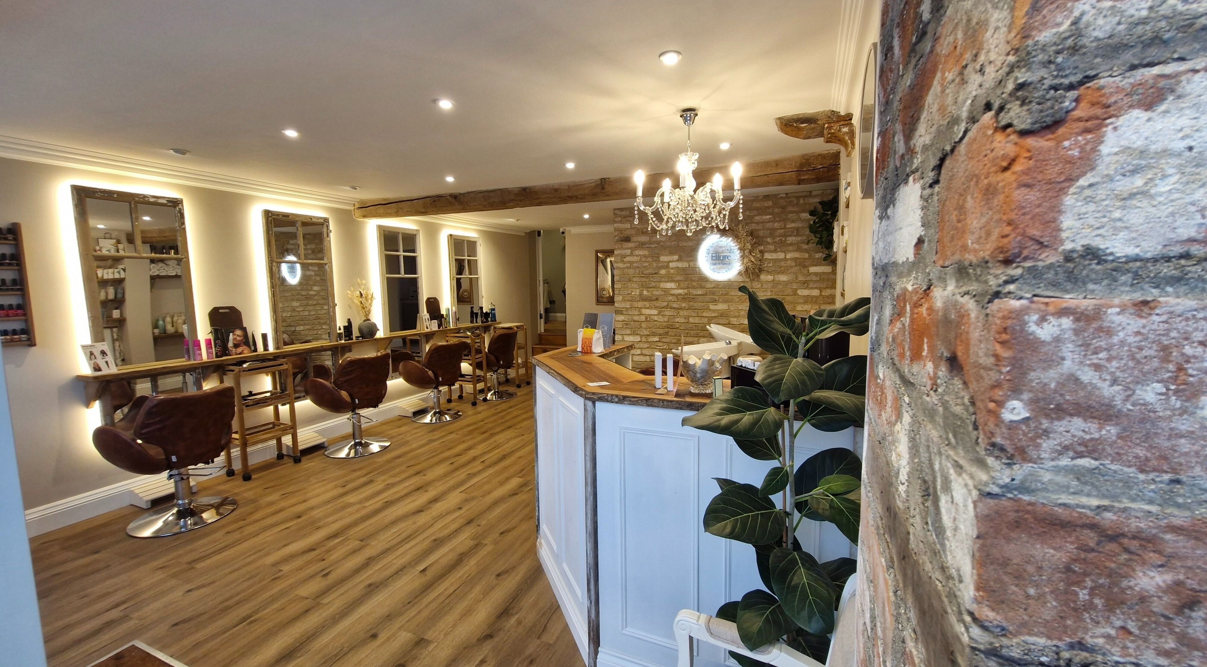 Chic interiors of Ellure Hair and Beauty in Downton, England, GB showcasing elegant styling stations and decor.