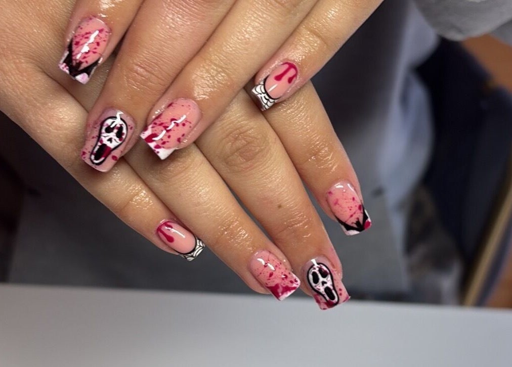 Spooky horror-themed nail art at Glossed by Jorjah, Chelmsford, England, GB. Elegant design with red splatter details.