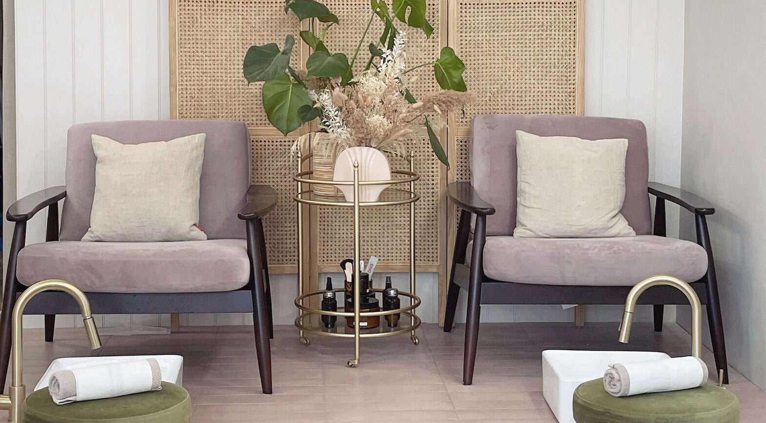 Pampering lounge at L&W Brixton | BIAB Nails & Brows, London, England. Cozy chairs with plants and pedicure setup.