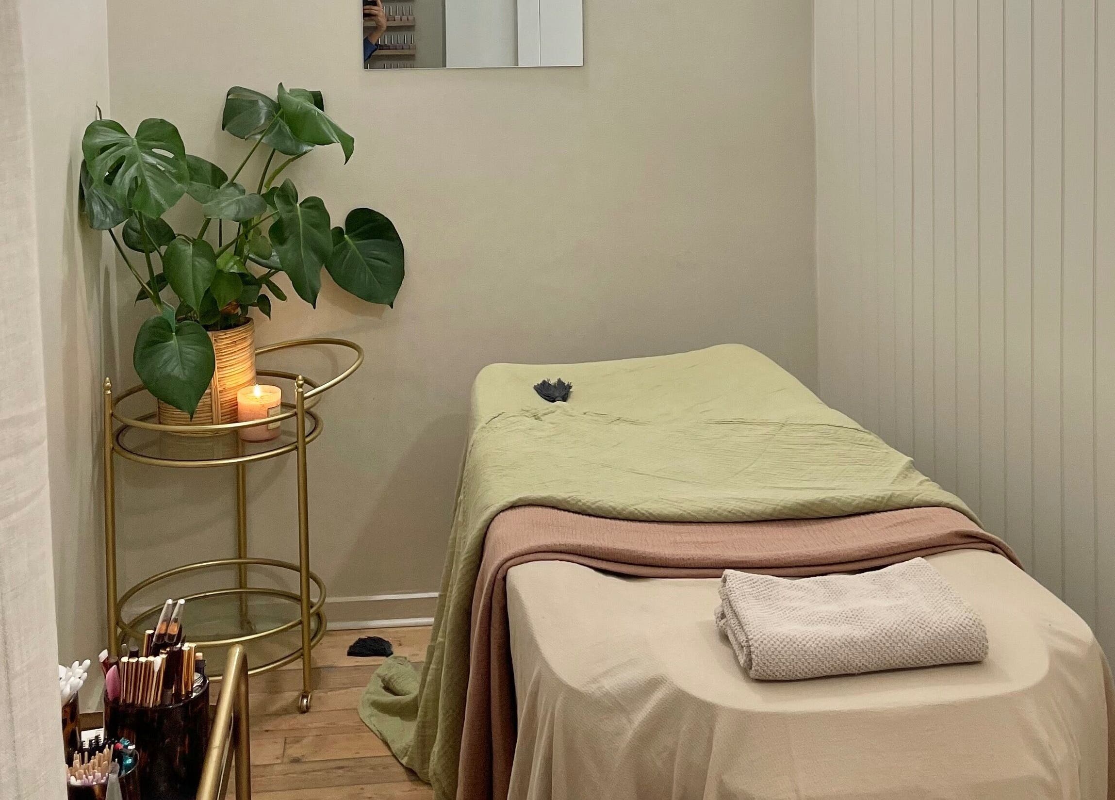 Calm treatment room at L&W Brixton | BIAB Nails & Brows, London, England, GB, with a massage table and plants.