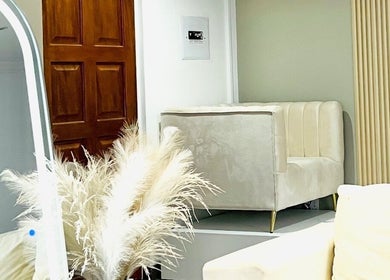 Elegant seating area at My Beauty Emporium, Centurion, Gauteng, ZA, featuring plush decor and ambient lighting.