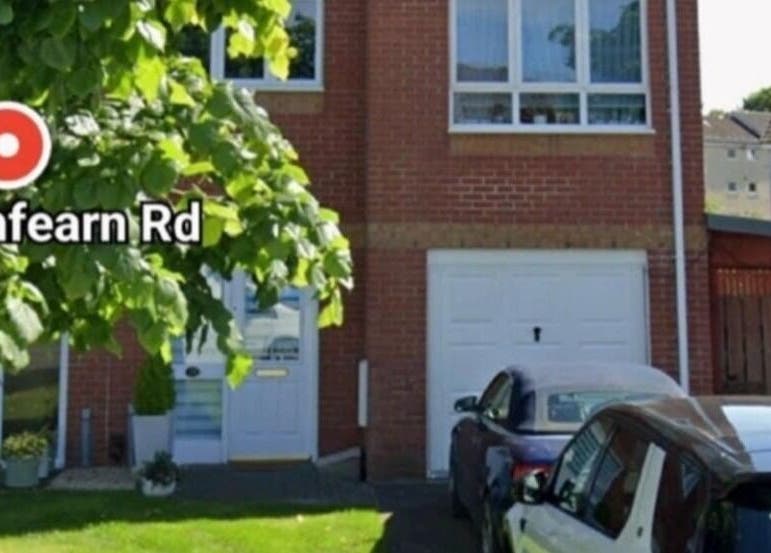 Front view of Human Balance venue on Drumfearn Rd, Glasgow, Scotland, GB, with greenery and parked cars.