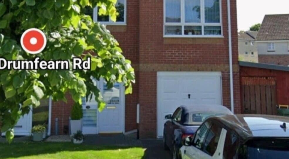Front view of Human Balance venue on Drumfearn Rd, Glasgow, Scotland, GB, with greenery and parked cars.
