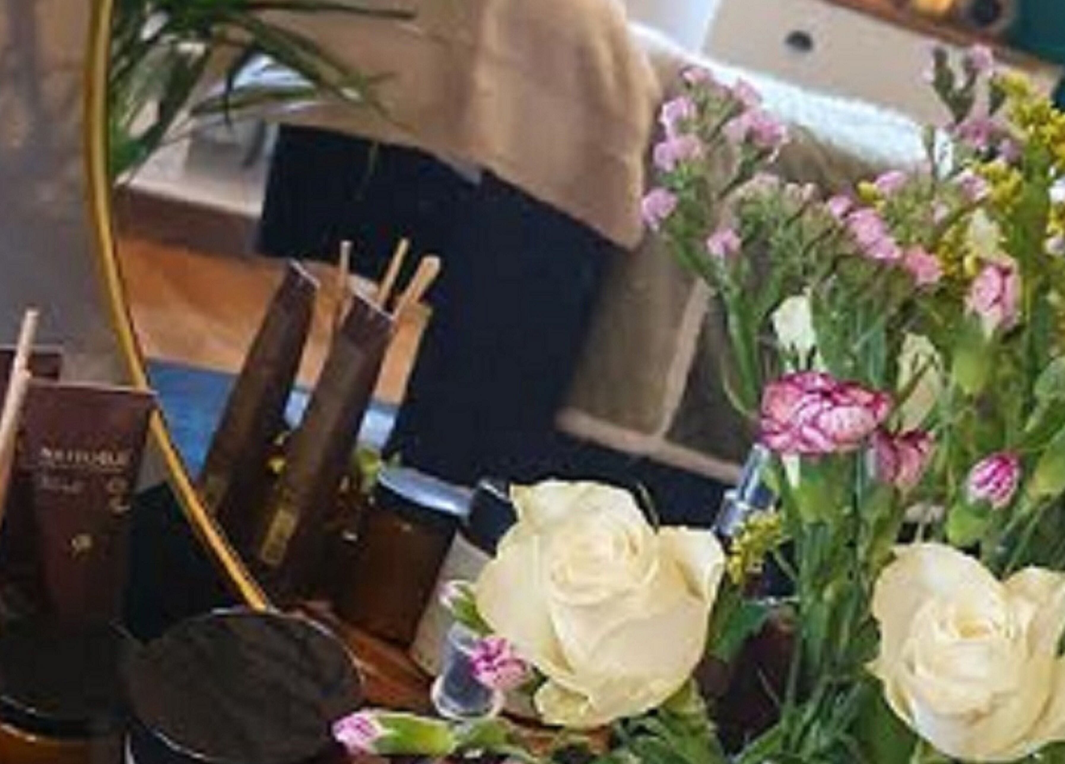 Tranquil spa setup with flowers and beauty products at Human Balance, Glasgow, Scotland, GB.