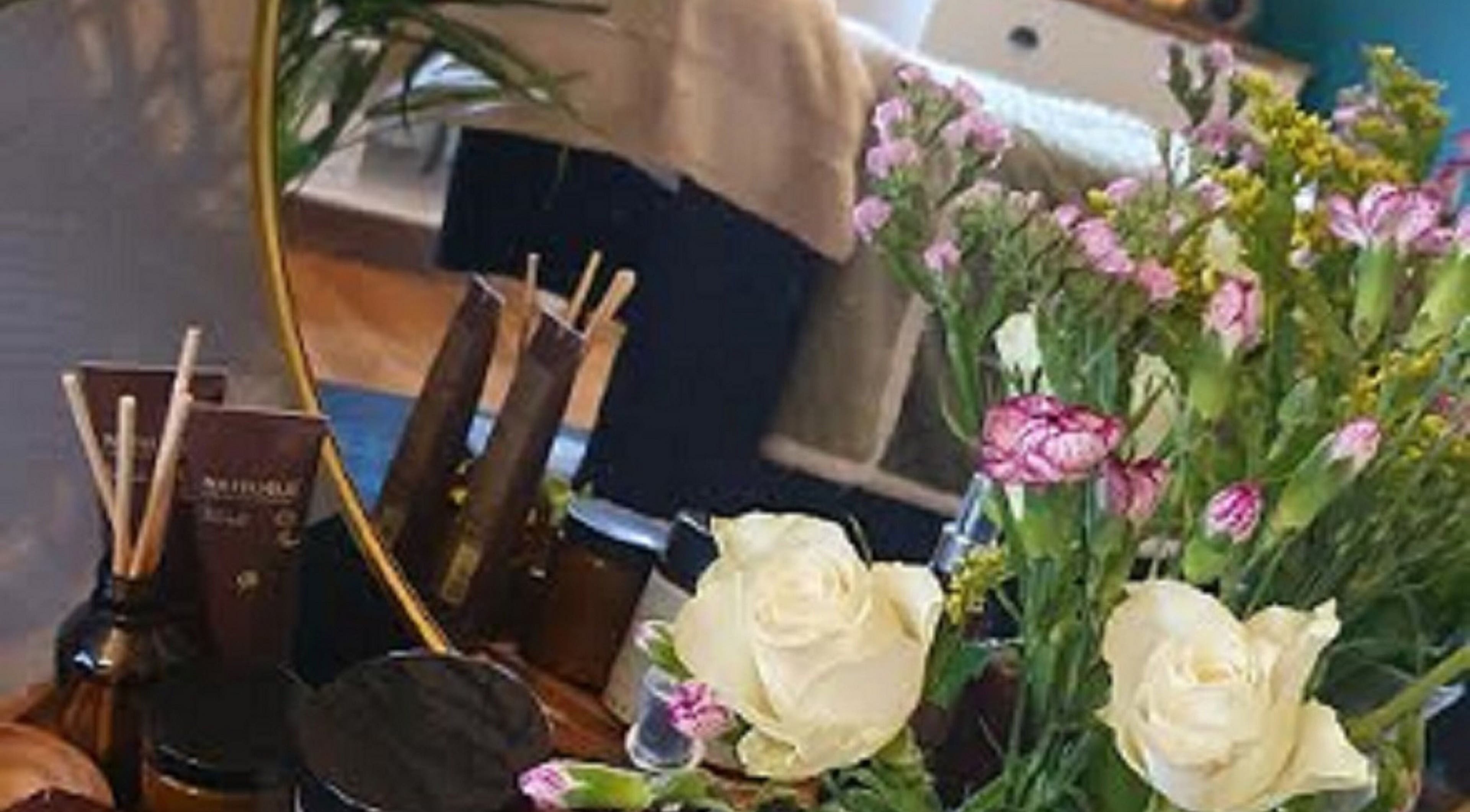 Tranquil spa setup with flowers and beauty products at Human Balance, Glasgow, Scotland, GB.