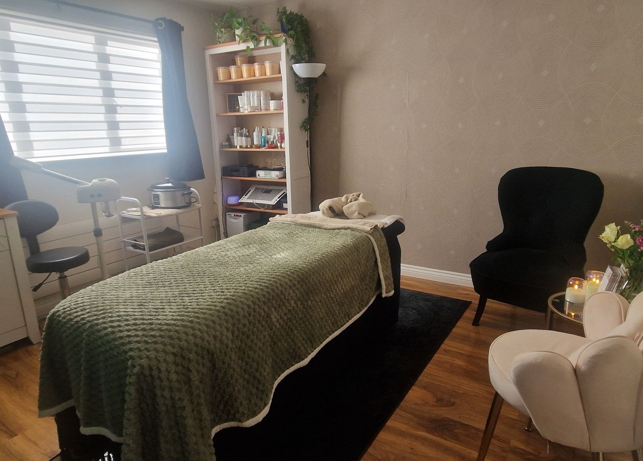 Serene spa room at Human Balance, Glasgow, Scotland, GB featuring a massage table and cozy seating.