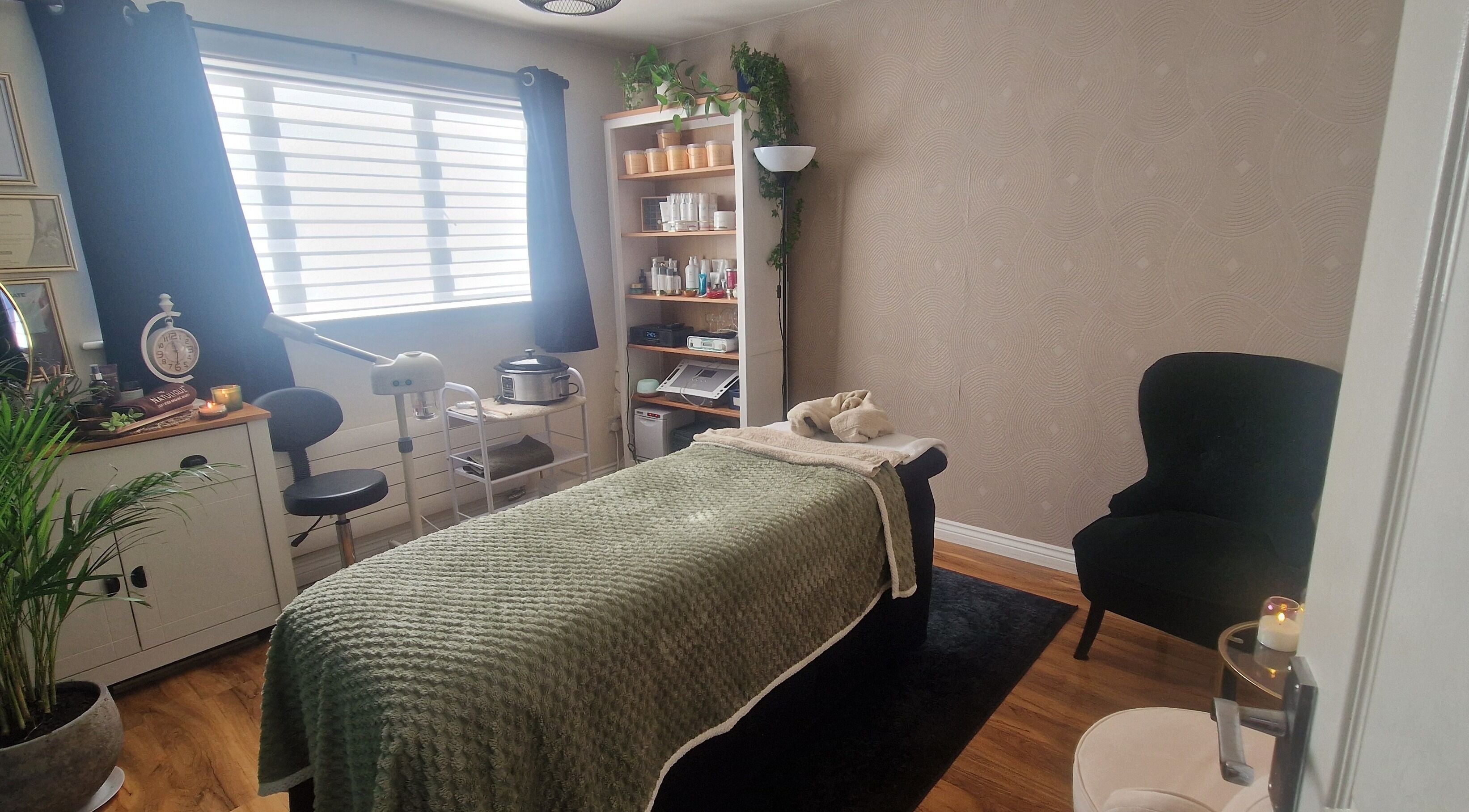 Tranquil spa room at Human Balance in Glasgow, Scotland, GB featuring a massage bed and ambient lighting.