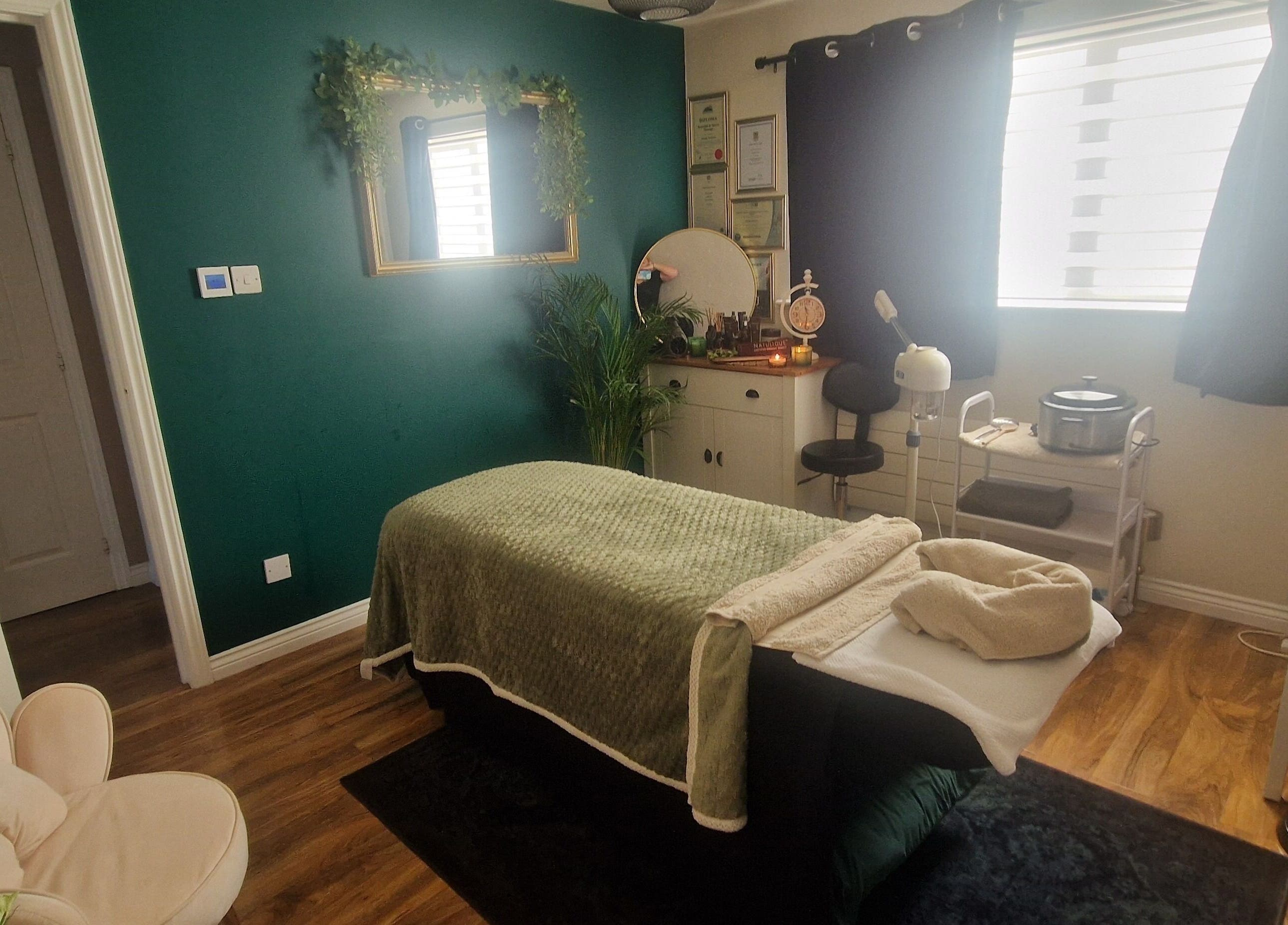 Tranquil massage room at Human Balance, Glasgow, Scotland, GB with plush bed and calming decor.
