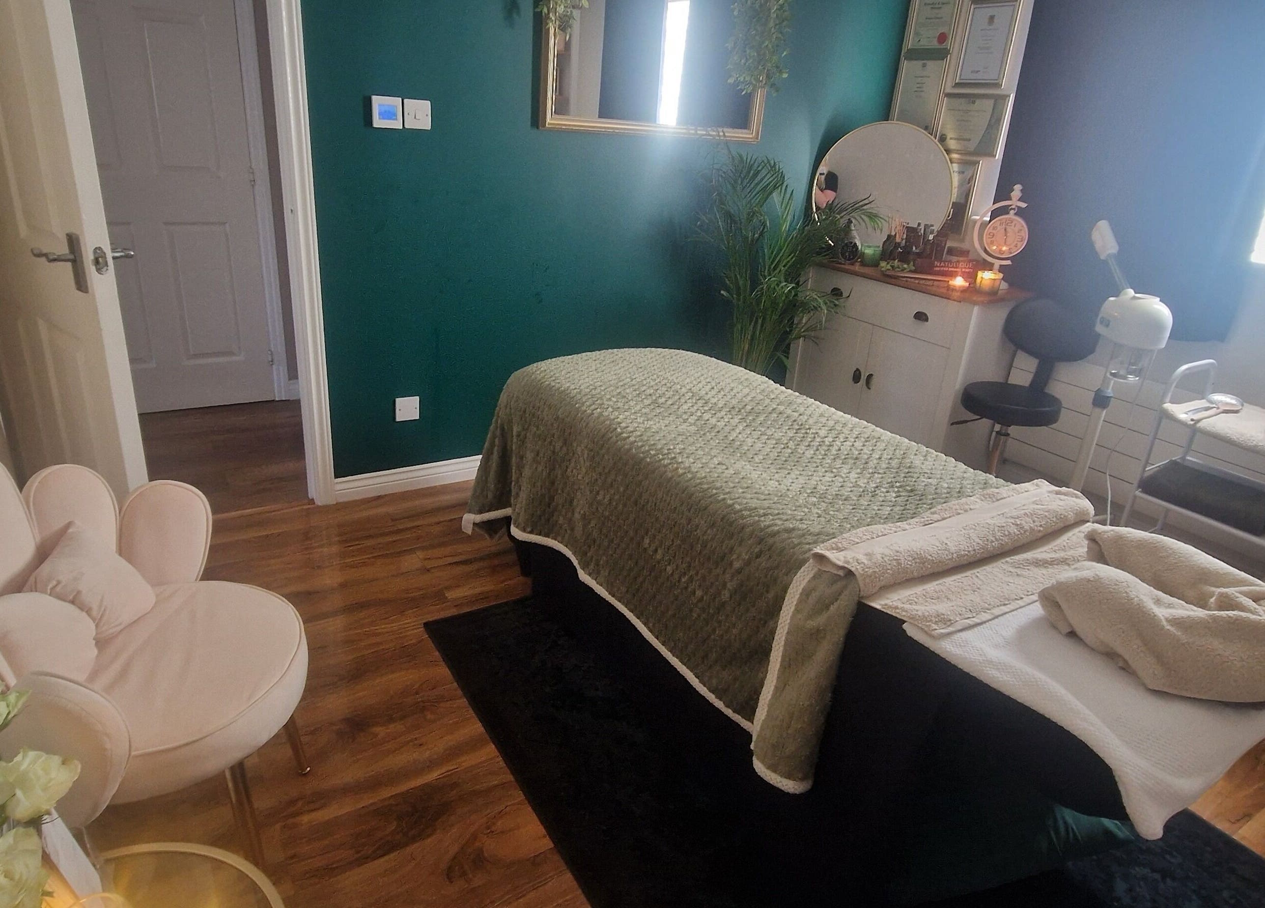 Serene treatment room at Human Balance in Glasgow, Scotland, GB, featuring a massage table and cozy decor.